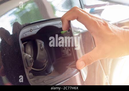 Close up hand man open the fuel tank cover in the car Stock Photo