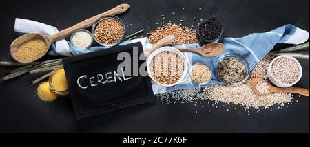 Different types of cereals in bowls on  black background. Healthy nutrition eating. Top view with copy space Different types of cereals in bowls on  b Stock Photo