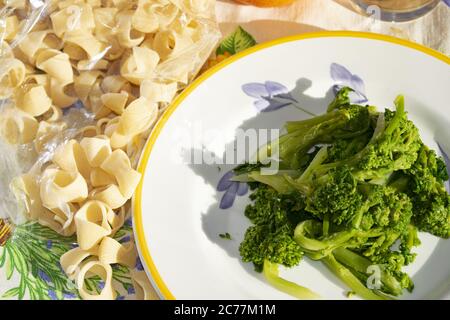 cooking dry pasta with steamed top turnip Stock Photo