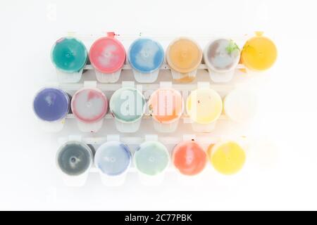 jars with gouache paints on white background Stock Photo