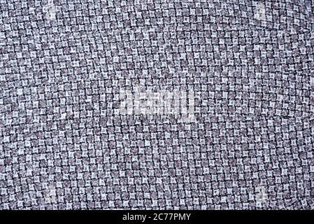 Gray and white wool fabric with a pattern of teeth. Background Stock Photo