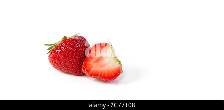 A whole and a half red organic juicy, fresh Belgian strawberry isolated on a white background with space for text. Stock Photo