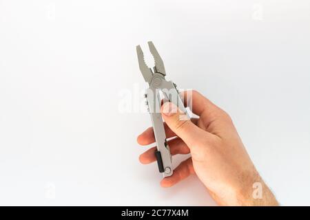 pliers in hand on white background Stock Photo