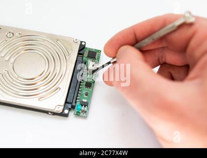 a man repairs hard drive Stock Photo
