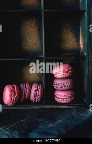 traditional French colored almonds lie in rows in an old wooden box. Rustic, copy space. Stock Photo