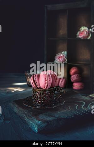 traditional French colored almonds lie in rows in an old wooden box. Rustic, copy space. Stock Photo