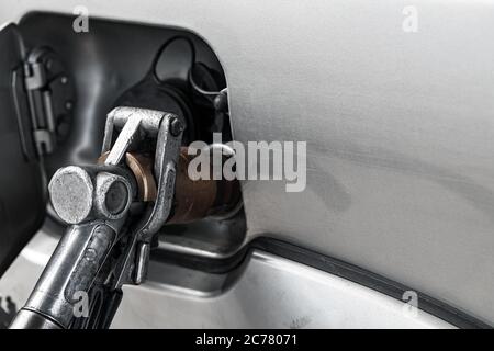 LPG filling of a personal car on a gas station, close-up photo of refueling gun Stock Photo