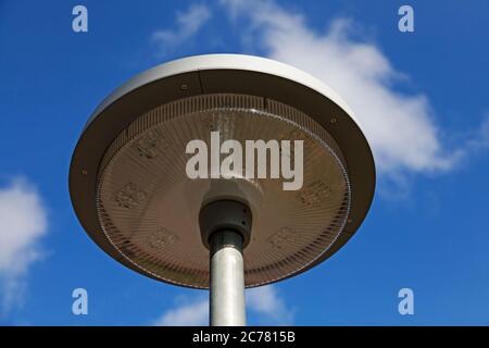 a new street lamp with led light against a blue summer sky Stock Photo