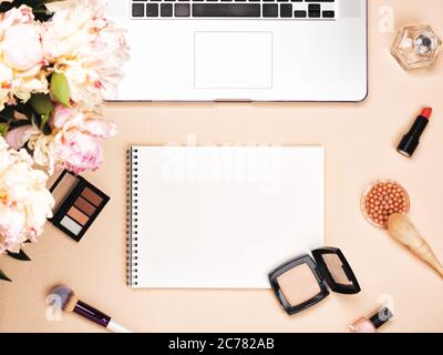 Beauty blogger workspace with laptop and cosmetics and peony Stock Photo