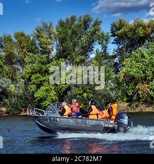 Russia,Astrakhan Oblast, Volga Delta,  A boat transporting a family in the Water Sport Volga estuary Stock Photo