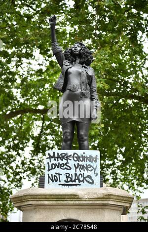 A sign is placed at the base of A Surge of Power (Jen Reid) 2020, by prominent British sculptor Marc Quinn, which has been installed in Bristol on the site of the fallen statue of the slave trader Edward Colston. Stock Photo