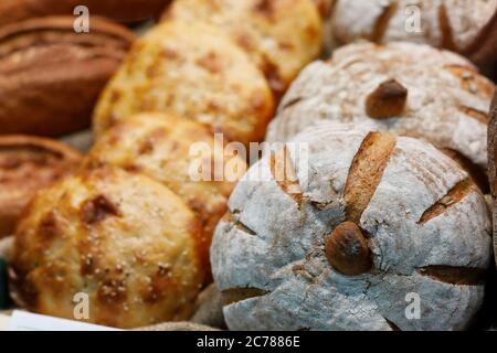 Different types of bread on the bakery shelf. Selective focus. Stock Photo