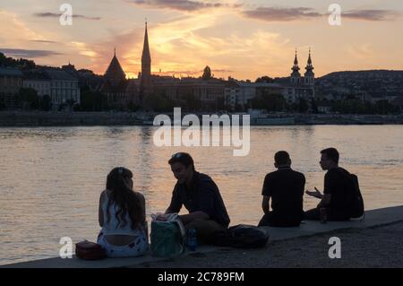 Budapest, Hungary. 14th July, 2020. People spend their leisure time on the bank of the Danube River after the COVID-19 restrictions were lifted in downtown Budapest, Hungary, on July 14, 2020. Credit: Attila Volgyi/Xinhua/Alamy Live News