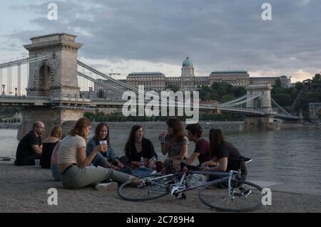 Budapest, Hungary. 14th July, 2020. People spend their leisure time on the bank of the Danube River after the COVID-19 restrictions were lifted in downtown Budapest, Hungary, on July 14, 2020. Credit: Attila Volgyi/Xinhua/Alamy Live News
