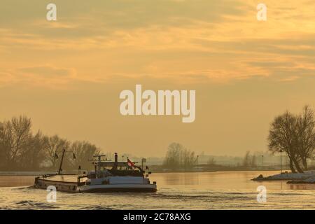 Dutch riverboat transporting goods during winter on the river IJssel Stock Photo