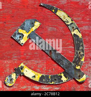 Part of an old wooden shipwreck with the cccp hammer and sickle in steel attached to it Stock Photo