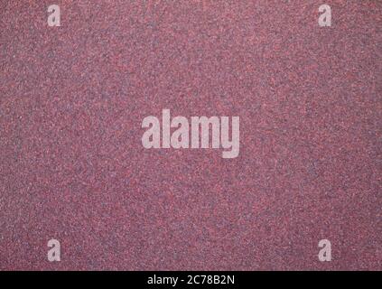 Fine emery paper texture. In a red purple version. Stock Photo