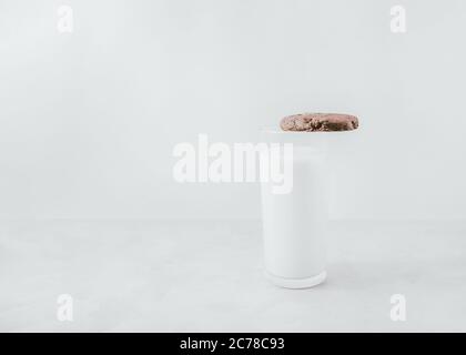 Cookie and milk Template for posters and banners with copy space Chocolate cookie is lying on a glass of milk Stock Photo