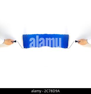 Shot of two hands with paintrollers painting white background blue Stock Photo