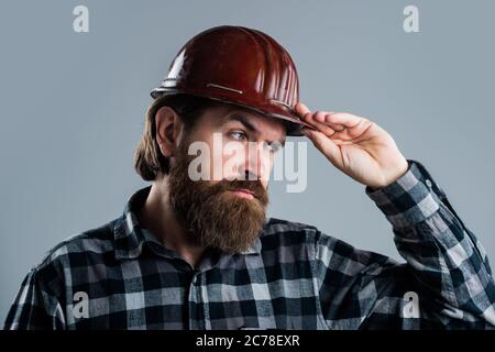 it will be perfect. brutal builder in helmet. bearded repairman. confident construction engineer. professional architect. repair and building. responsible for safety. serious male worker in hard hat. Stock Photo