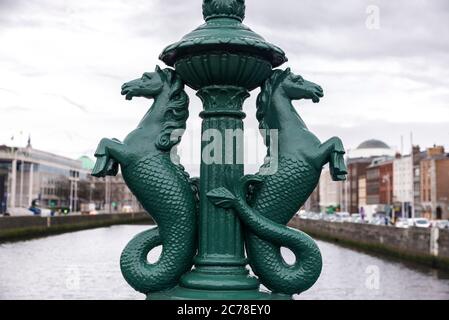 Ornate cast iron lamp standards, featuring the mythical hippocampus: half horse, half fish, on the Grattan Bridge ( Droichead Grattan ), road bridge s Stock Photo