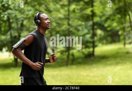 Side view of african man jogger training at park Stock Photo