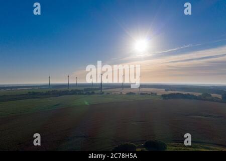 Grabow, Germany. 11th July, 2020. Windmills are turning on the horizon. (aerial view with drone) Credit: Stephan Schulz/dpa-Zentralbild/ZB/dpa/Alamy Live News Stock Photo