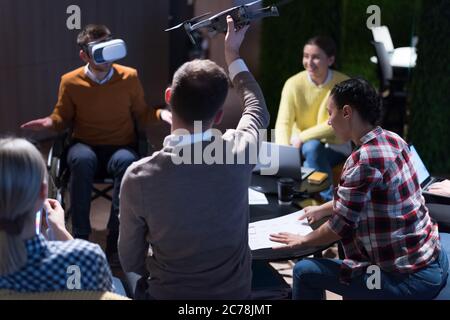 Young team of experienced professionals planning the development of new successful project. Diverse group of architects working in coworking office us Stock Photo