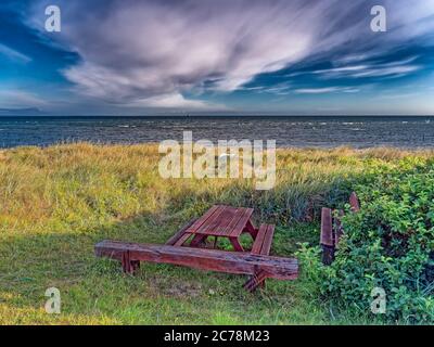 Bench and table on a lonely beach, Denmark Stock Photo