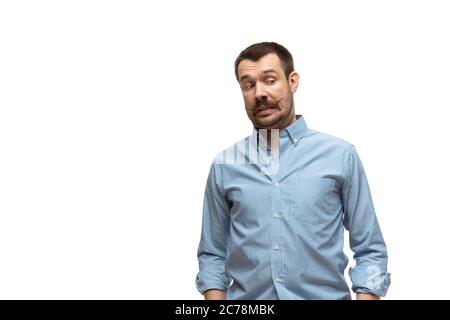 Amused. Young man with funny, unusual popular emotions and gestures isolated on white studio background. Human emotions, facial expression, sales, ad concept. Trendy look inspired by memes. Stock Photo