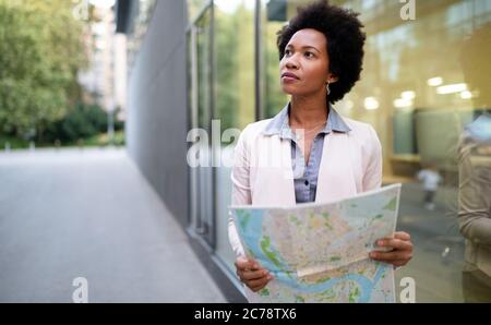 Young beautiful woman traveler lost in the city. Tourism, vacation, people concept Stock Photo
