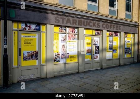 A closed boarded-up high Street Starbucks coffee shop retail unit is pictured in the center of Bath, Somerset, England, UK.  June 2020 Stock Photo