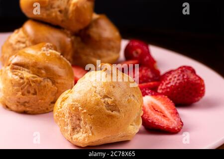 Delicious quiche with strawberries on a pink plate. Cake. Stock Photo