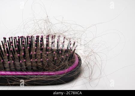 Hair loss on a comb on a white background. Baldness. Stock Photo
