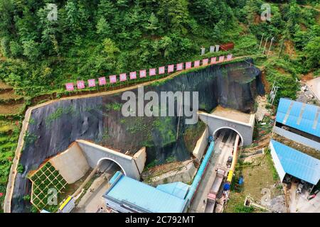 Weining. 15th July, 2020. Aerial photo taken on July 15, 2020 shows the Mezhan tunnel of the Weining-Weizhang expressway in Weining, southwest China's Guizhou Province. The Mezhan tunnel of the Weining-Weizhang expressway, located in Mezhan Town of Weining County, was dug through on Wednesday, as construction of the 28 km-long expressway, with a designed speed of 80 kph, has proceeded smoothly. Credit: Liu Xu/Xinhua/Alamy Live News Stock Photo