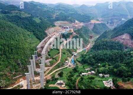 Weining. 15th July, 2020. Aerial photo taken on July 15, 2020 shows the construction site of the Weining-Weizhang expressway in Weining, southwest China's Guizhou Province. The Mezhan tunnel of the Weining-Weizhang expressway, located in Mezhan Town of Weining County, was dug through on Wednesday, as construction of the 28 km-long expressway, with a designed speed of 80 kph, has proceeded smoothly. Credit: Liu Xu/Xinhua/Alamy Live News Stock Photo