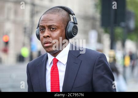 Westminster, London, UK. 15th July, 2020. Conservative MP Bim Afolami walks through the crowd but does not interact. Pro European Anti Brexit protesters and campaigners around Steve (Steven) Bay hold their weekly protest outside the gates at the Houses of Parliament and in Parliament Square, Westminster as MP's hold PMQs inside the House of Commons. Credit: Imageplotter/Alamy Live News Stock Photo