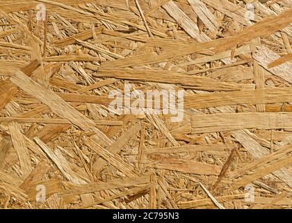 OSB sheet is made of brown wood chips pressed together into a wooden floor Stock Photo