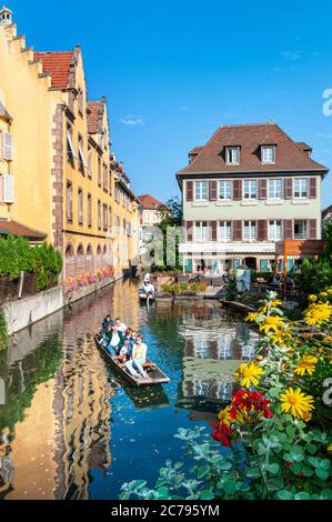 COLMAR ALSACE canal boat trip 'Petite Venise' visitors exploring the waterway on a perfect late summer day Colmar Alsace France Stock Photo