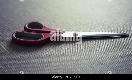 scisors with red plastic handle. Instagram toning Stock Photo