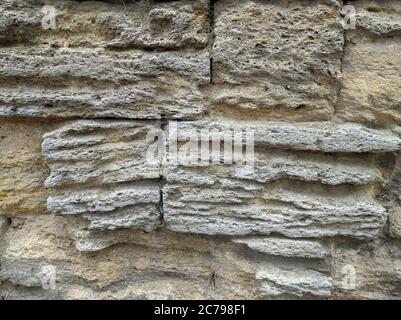 brick wall of old stones yellow shell Stock Photo