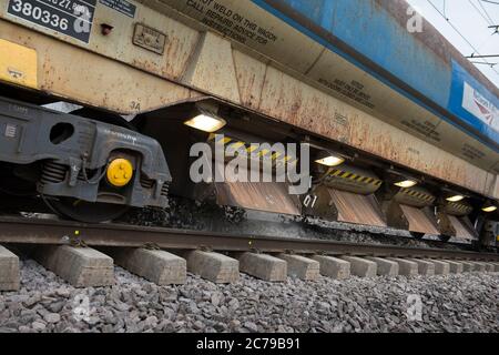 Network Rail train laying new ballast on track on a stretch of railway in England, UK. Stock Photo