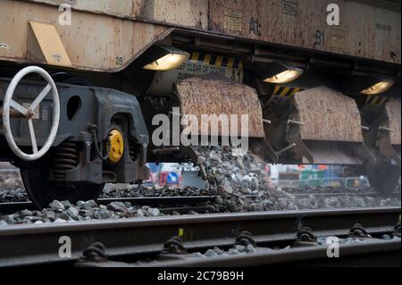 Network Rail train laying new ballast on track on a stretch of railway in England, UK. Stock Photo