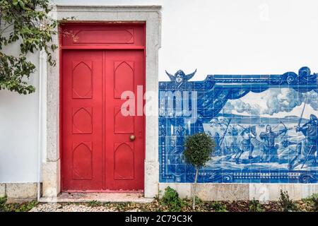 Colorful wooden door in the facade of a typical Portuguese house at Lisbon, Portugal. Stock Photo