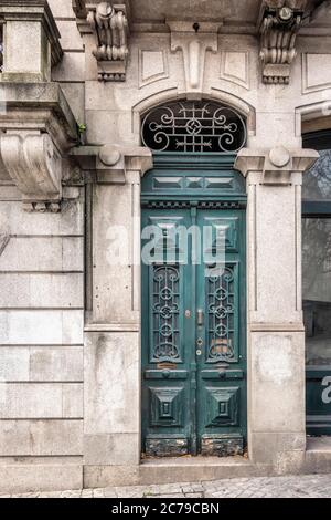 Colorful wooden door in the facade of a typical Portuguese house at Porto, Portugal. Stock Photo