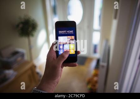 POV Man accessing home automation from smart phone Stock Photo