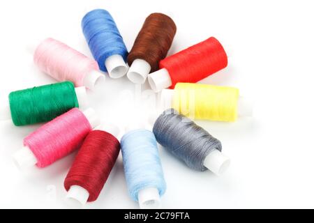 Colorful cotton craft sewing threads in flower shape isolated on white background. Stock Photo