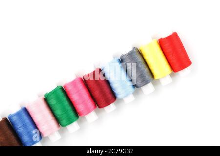 Colorful cotton craft sewing threads multicolored in a row isolated on a white background. Stock Photo