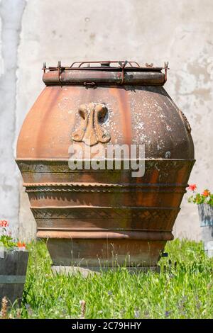 Large earthenware jar in the garden Stock Photo