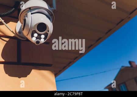 technician female setup cctv camera on wall. Stock Photo